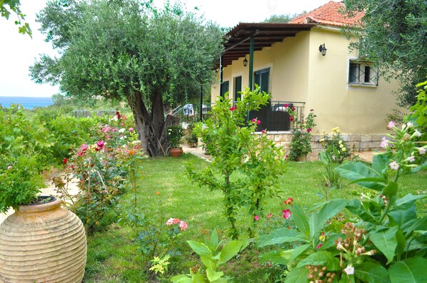 Large, enclosed terrace with garden furniture.