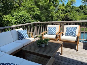 Outdoor sectional on the large mahogany deck overlooking the pool. 