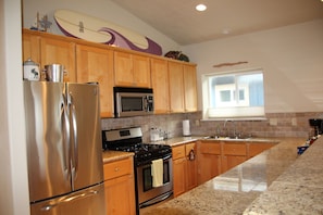 Kitchen located on upper level with  living area and dining area