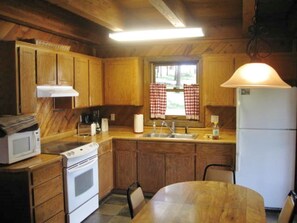 Well stocked kitchen opens to porch