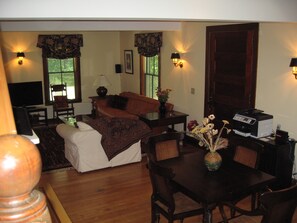 Game/"Work" table in foreground; love seat and sofa in rear