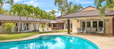 Inviting resort-style pool with crystal-clear waters, framed by a beautifully landscaped garden—your luxury retreat at home.