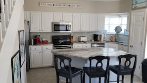 Kitchen with granite counters and huge center island with breakfast bar