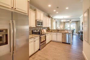 Fridge, oven, washing machine in the kitchen