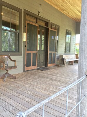 Front porch welcoming you. Handmade screen doors.