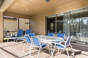 Patio table with chairs and BBQ gas grill