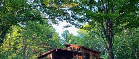 Beautiful cabin nestled in the woods.