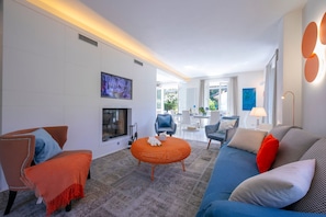 The living room has plenty of seats and enjoys plenty of light