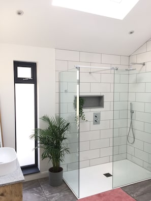 Main bathroom with large shower and bath.