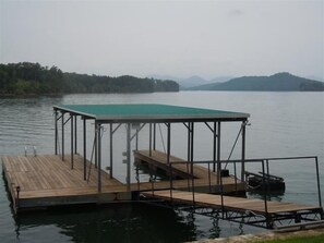 covered dock with boat slip and swim platform