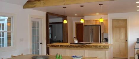 Dining room, looking into kitchen with the original 1940 roof detail over bar