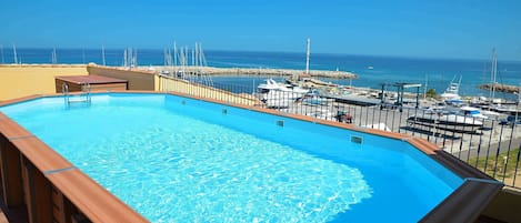The unbelievable rooftop pool is great for cooling off and enjoying spectacular views of the marina
