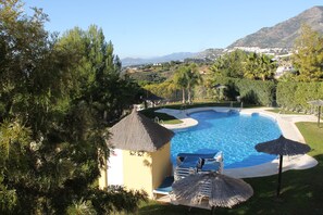 Large communal pool set in beautiful landscaped gardens.