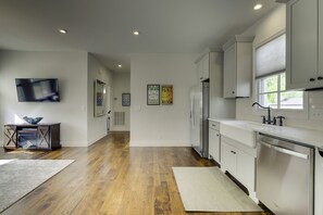 Shows living area and hallway leading to bedrooms.