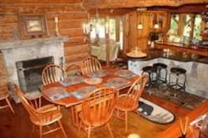 Dining room area with 1st wood fireplace. Chef’s kitchen in background.