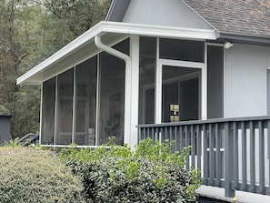 Private screen porch with walkway to main house. 