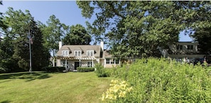 Large front yard surrounded by hedges.