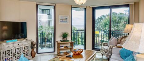 Bright sitting room.  Full pull-out sofa, love seat, arm chair, 50" smart TV.