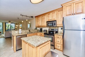 Kitchen.  Granite countertops, SS appliances, chock full of dishes.