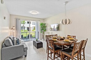 Resplendent Living and Dining Dining Area of the Apartment in Orlando Florida - A wooden dining table  - Offering a cozy setting for shared meals and cherished conversations - Smart TV and Netflix