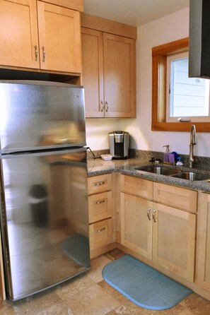 Stainless frig with quartz counter top with   Keurig coffee and tea supplied
