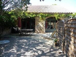 Terrasse ombragée avec accès piscine.