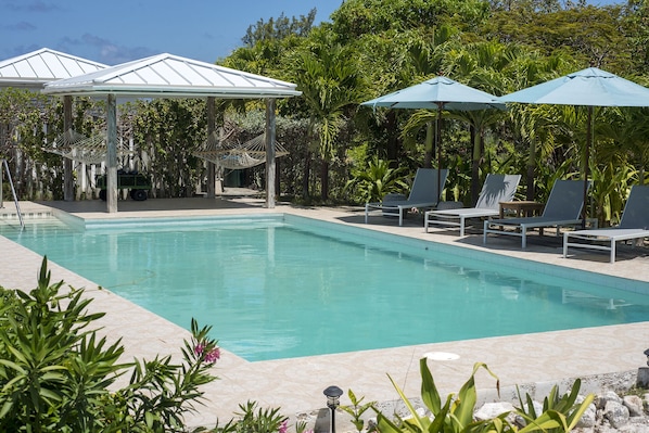 Utopia's pool, deck and shaded hammocks