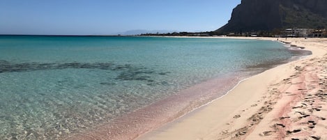 The coral-colored beach and Monte Monaco