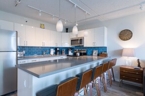 Kitchen with breakfast bar is a terrific way to enjoy coffee and breakfast or return from the beach for lunch