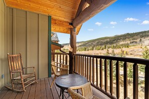 Private balcony with outdoor seating and mountain views.