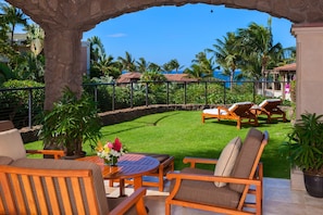 Covered Patio and Sitting Area Opens to the Garden and Partial Ocean Views