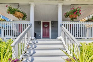 Walk between the overflowing flower pots onto the beautiful covered front porch!