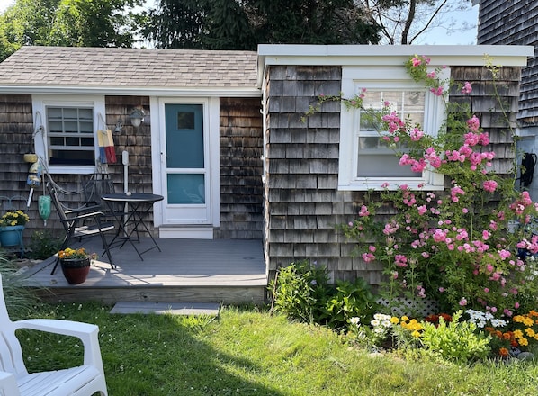 Deck and entrance. Bedroom window on the right.