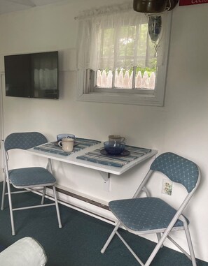Table open with 2 folding chairs