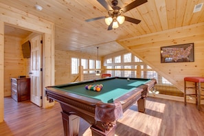 Loft with a game room, including a full-size pool table.