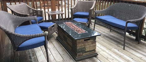 fire table to enjoy with friends on upstairs deck overlooking trees