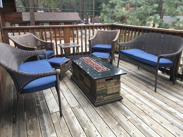 fire table to enjoy with friends on upstairs deck overlooking trees