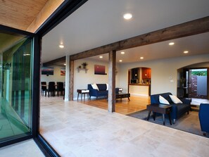 Sliding door leading to deck , ground level , living room kitchen , dining room 