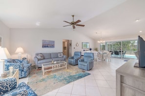 Immediately upon entering, the comfortable indoor area flows seamlessly into the Florida lanai life.