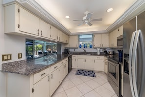 The conveniently-located kitchen features granite counter tops, new appliances, and more dishware and gadgets than your kitchen at home.