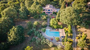 Panoramic view of the villa, garden, and park around it.