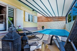 A welcome package for guests of the luxury Croatian villa for vacation and rental LeLu next to the comfortable deckchairs and swimming pool in Split