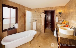 Master suite bathroom with a surprise outdoor shower just past the white door. 