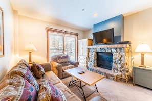Living area featuring gas fireplace, flat screen TV and access to the private balcony.
