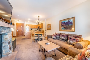 Living area featuring gas fireplace, flat screen TV and access to the private balcony.