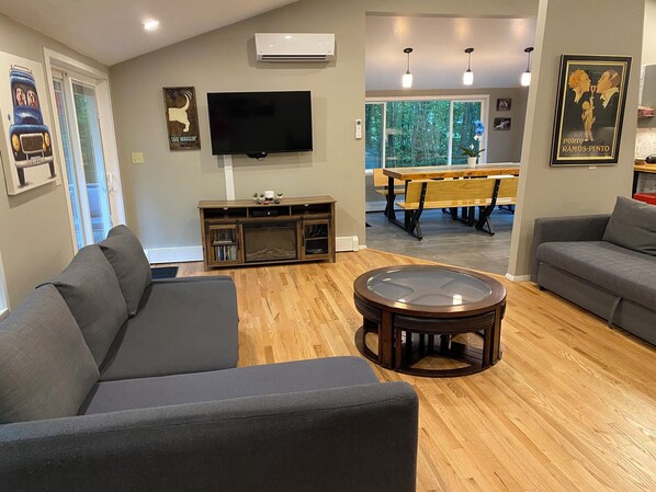 upper floor open concept living room with kitchen and dining area