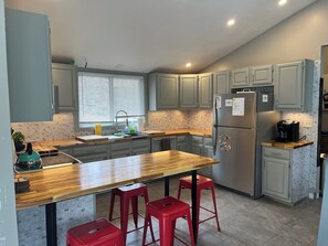 upper floor open concept living room with kitchen and dining area