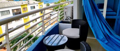 balcony with sea view, comfortable chairs and hammock