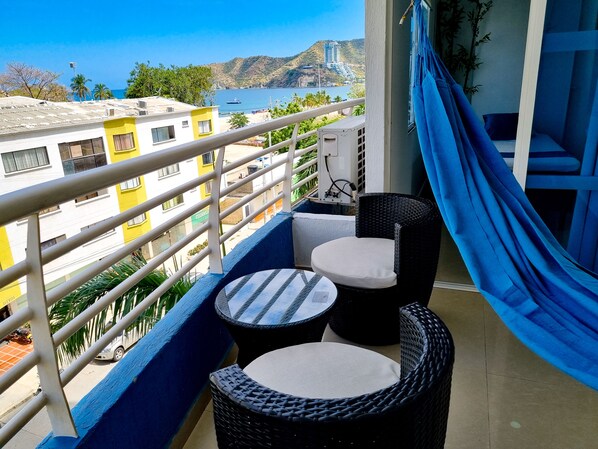 balcony with sea view, comfortable chairs and hammock