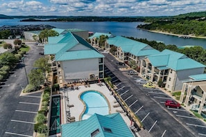 The building is right next to the pool.